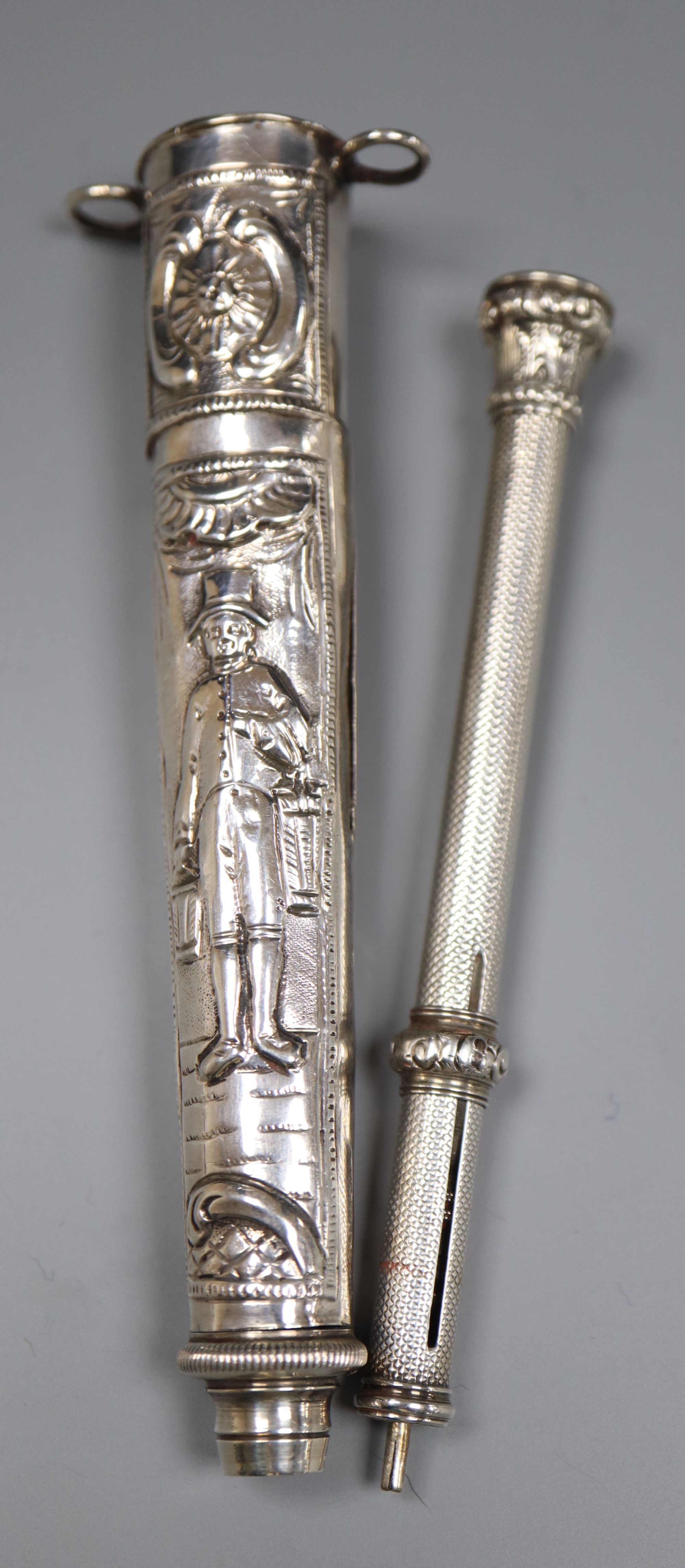 Two white metal propelling pencils, including engine turned with amethyst coloured intaglio set terminal, 93mm.
